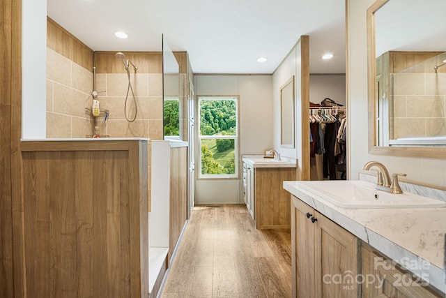 410 Fork Mountain Rd, Bakersville, NC 28705 - full bathroom featuring wood finished floors, a tile shower, two vanities, recessed lighting, and a spacious closet