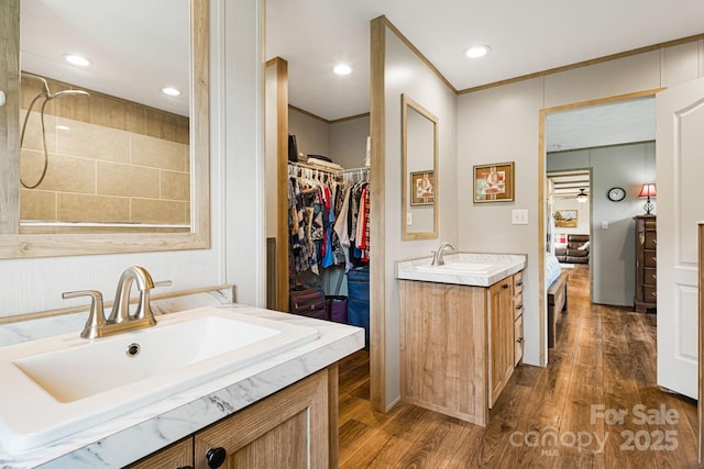410 Fork Mountain Rd, Bakersville, NC 28705 - full bath with two vanities, wood finished floors, ensuite bath, a walk in closet, and recessed lighting
