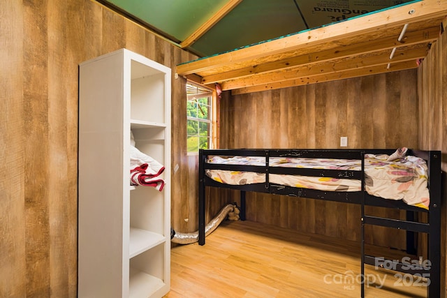 410 Fork Mountain Rd, Bakersville, NC 28705 - bedroom with wood finished floors and wooden walls