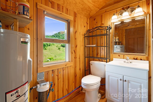 410 Fork Mountain Rd, Bakersville, NC 28705 - bathroom featuring electric water heater, lofted ceiling, toilet, wood walls, and vanity