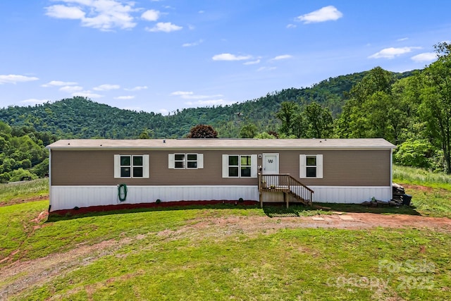 410 Fork Mountain Rd, Bakersville, NC 28705 - manufactured / mobile home featuring a forest view, a front lawn, and a mountain view