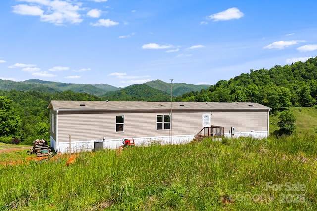 410 Fork Mountain Rd, Bakersville, NC 28705 - back of property with a mountain view, central AC unit, and a view of trees