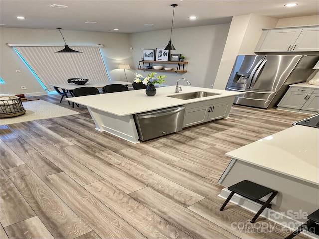 1510 Old Rivers Rd Unit 171, Concord, NC 28027 - kitchen with stainless steel appliances, light wood finished floors, a kitchen island with sink, light countertops, and recessed lighting