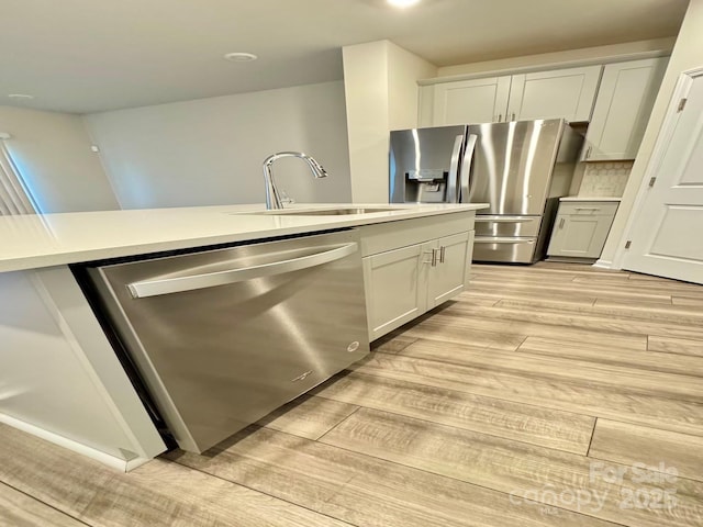 1510 Old Rivers Rd Unit 171, Concord, NC 28027 - kitchen featuring stainless steel appliances, light wood-style floors, light countertops, and tasteful backsplash