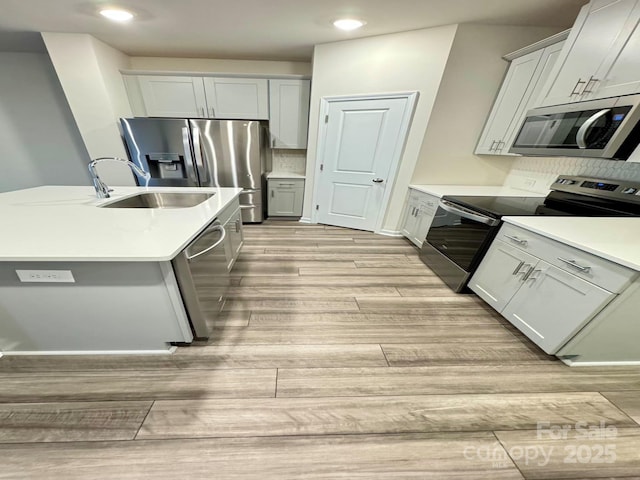1510 Old Rivers Rd Unit 171, Concord, NC 28027 - kitchen with appliances with stainless steel finishes, light wood finished floors, decorative backsplash, light countertops, and recessed lighting