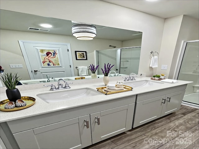 1510 Old Rivers Rd Unit 171, Concord, NC 28027 - bathroom featuring double vanity, a shower stall, and wood finished floors