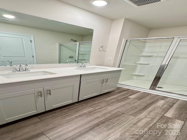 1510 Old Rivers Rd Unit 171, Concord, NC 28027 - bathroom with wood finished floors, a shower stall, double vanity, and recessed lighting