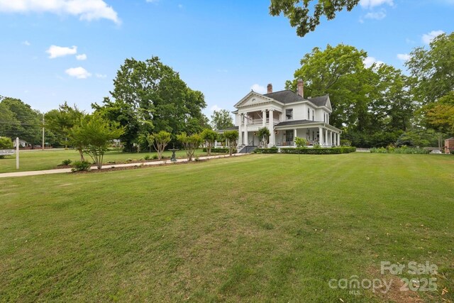 530 E Rutledge Ave, Gaffney, SC 29340 - greek revival inspired property featuring a porch, a front yard, and a chimney