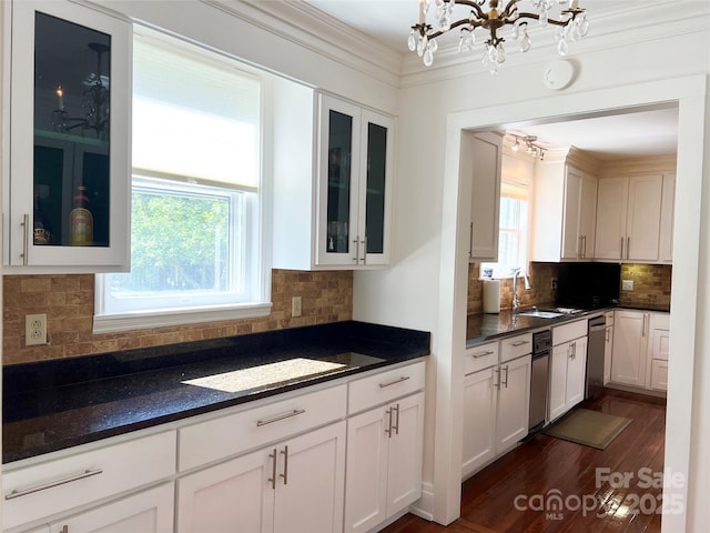 530 E Rutledge Ave, Gaffney, SC 29340 - kitchen with a chandelier, stainless steel dishwasher, white cabinets, tasteful backsplash, and dark wood-type flooring