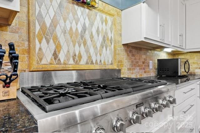 530 E Rutledge Ave, Gaffney, SC 29340 - kitchen featuring stove, white cabinets, tasteful backsplash, and dark stone counters