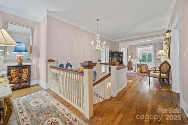 530 E Rutledge Ave, Gaffney, SC 29340 - corridor with an upstairs landing, a chandelier, wood finished floors, and ornamental molding