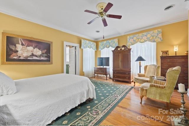 530 E Rutledge Ave, Gaffney, SC 29340 - bedroom featuring wood finished floors, crown molding, and a ceiling fan
