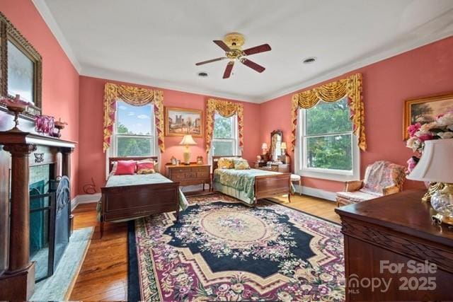 530 E Rutledge Ave, Gaffney, SC 29340 - bedroom with wood finished floors, ornamental molding, a premium fireplace, and ceiling fan