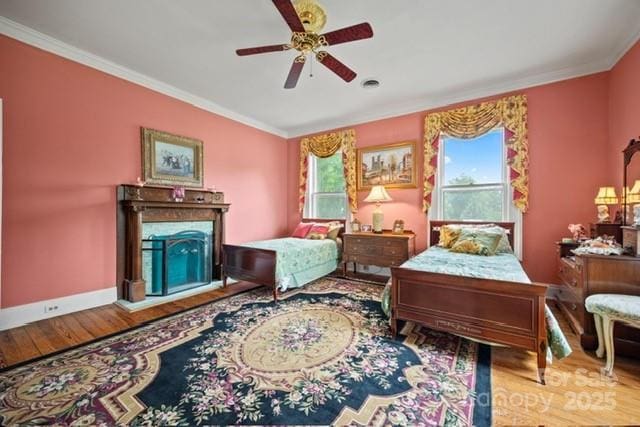 530 E Rutledge Ave, Gaffney, SC 29340 - bedroom featuring wood finished floors, crown molding, a fireplace, and a ceiling fan