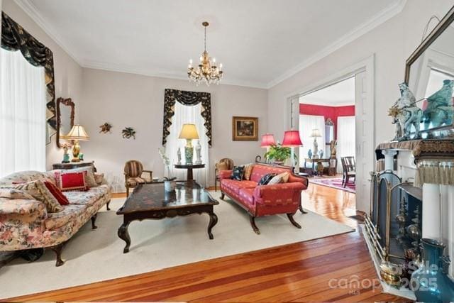 530 E Rutledge Ave, Gaffney, SC 29340 - living area featuring wood finished floors, a chandelier, a fireplace, and crown molding