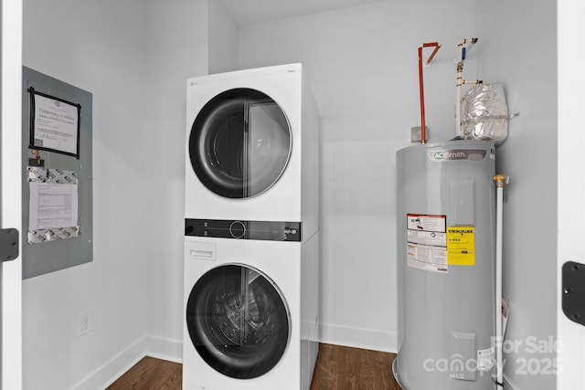 1922 Thomas Ave, Charlotte, NC 28205 - laundry room featuring electric water heater, stacked washer / drying machine, and dark wood-style flooring