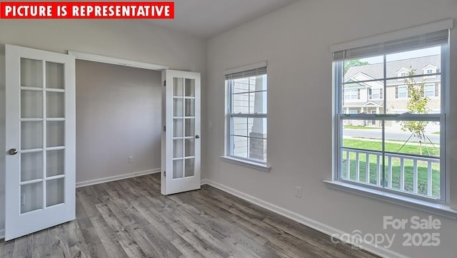 8036 Kennesaw Dr, Gastonia, NC 28056 - empty room featuring french doors, plenty of natural light, wood finished floors, and baseboards