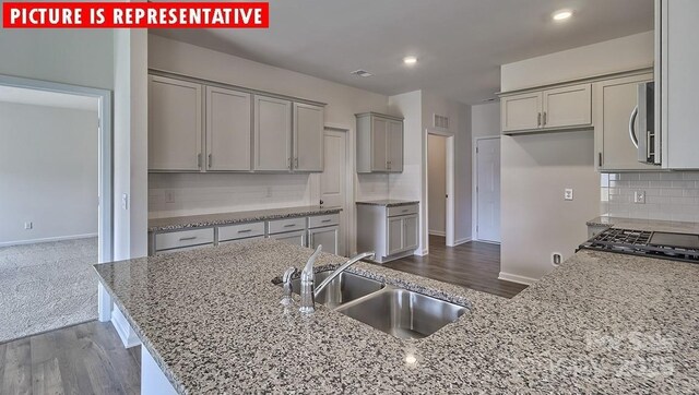 8036 Kennesaw Dr, Gastonia, NC 28056 - kitchen with gray cabinets, a sink, backsplash, baseboards, and recessed lighting