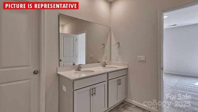 8036 Kennesaw Dr, Gastonia, NC 28056 - bathroom featuring double vanity and baseboards