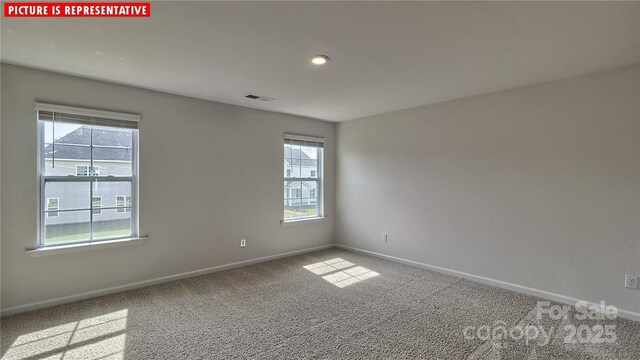 8036 Kennesaw Dr, Gastonia, NC 28056 - empty room featuring healthy amount of natural light, baseboards, and carpet flooring