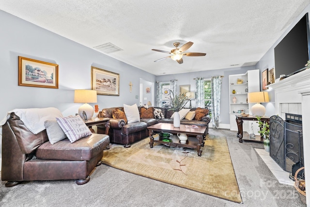 4236 Carrington Ct SW, Concord, NC 28027 - carpeted living area featuring a fireplace, a ceiling fan, and a textured ceiling