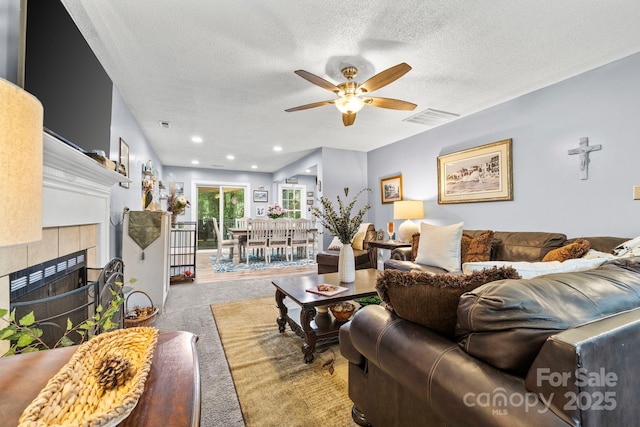 4236 Carrington Ct SW, Concord, NC 28027 - living room featuring ceiling fan, carpet flooring, a textured ceiling, and a fireplace