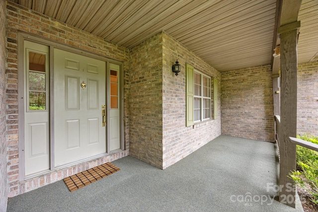 206 Pine Knot Trl, Hendersonville, NC 28739 - view of exterior entry featuring covered porch and brick siding