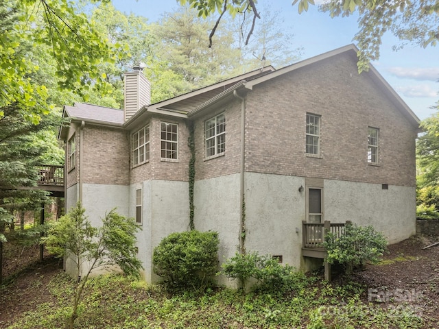 206 Pine Knot Trl, Hendersonville, NC 28739 - view of side of property with brick siding, a chimney, and stucco siding