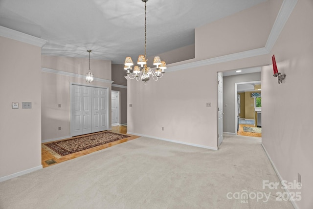 206 Pine Knot Trl, Hendersonville, NC 28739 - carpeted foyer with baseboards, a chandelier, and ornamental molding