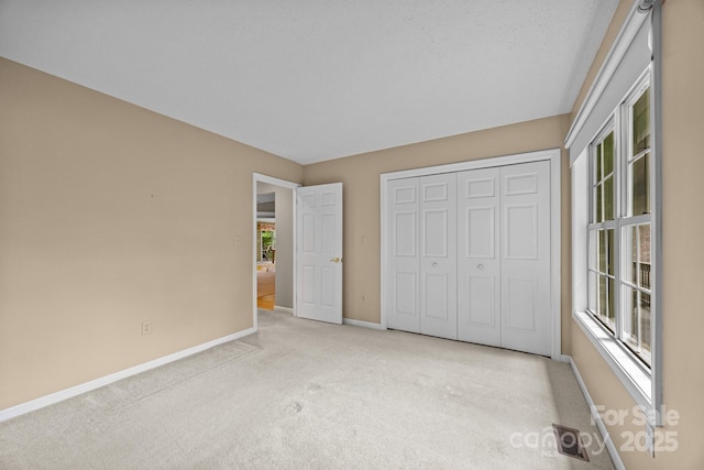 206 Pine Knot Trl, Hendersonville, NC 28739 - unfurnished bedroom with baseboards, carpet floors, and a closet