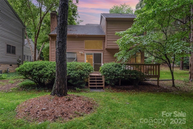 8968 St Croix Ln, Charlotte, NC 28277 - back of property featuring a wooden deck, a chimney, and a yard