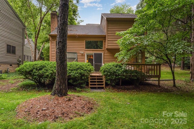 8968 St Croix Ln, Charlotte, NC 28277 - rear view of property featuring a wooden deck, a chimney, a lawn, and roof with shingles