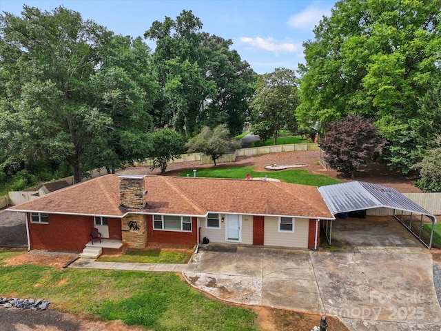 1810 13th Ave NE, Hickory, NC 28601 - view of front of house with driveway, a detached carport, and brick siding