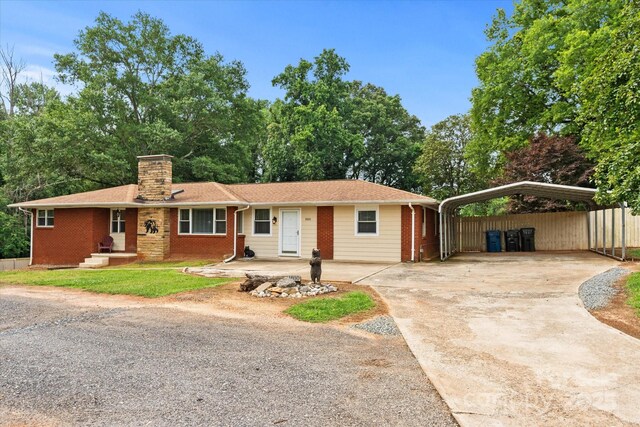 1810 13th Ave NE, Hickory, NC 28601 - ranch-style home featuring a detached carport, concrete driveway, a chimney, and brick siding