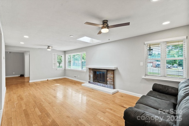 1810 13th Ave NE, Hickory, NC 28601 - living area with ceiling fan, a skylight, recessed lighting, a fireplace, and wood finished floors