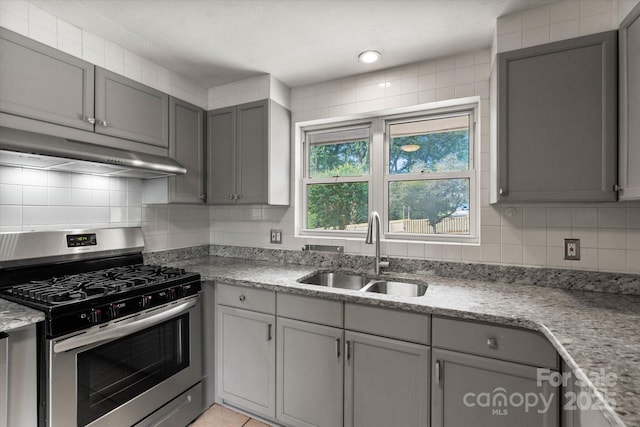 1810 13th Ave NE, Hickory, NC 28601 - kitchen with stainless steel range with gas stovetop, exhaust hood, gray cabinetry, and decorative backsplash