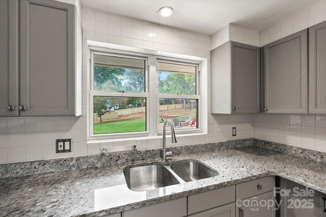 1810 13th Ave NE, Hickory, NC 28601 - kitchen with gray cabinets, decorative backsplash, and light stone counters