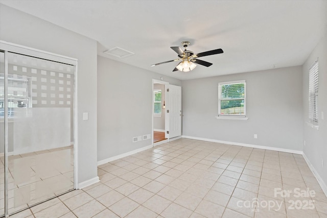 1810 13th Ave NE, Hickory, NC 28601 - empty room featuring a ceiling fan, light tile patterned flooring, and attic access
