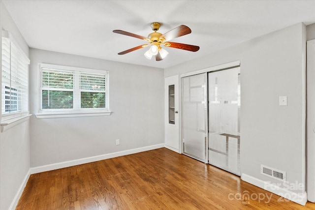 1810 13th Ave NE, Hickory, NC 28601 - unfurnished bedroom featuring wood finished floors, a closet, and a ceiling fan