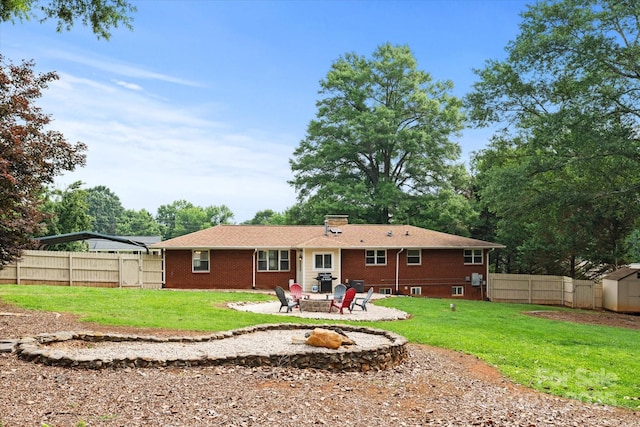 1810 13th Ave NE, Hickory, NC 28601 - rear view of house with a patio, brick siding, a storage shed, a fire pit, and a chimney
