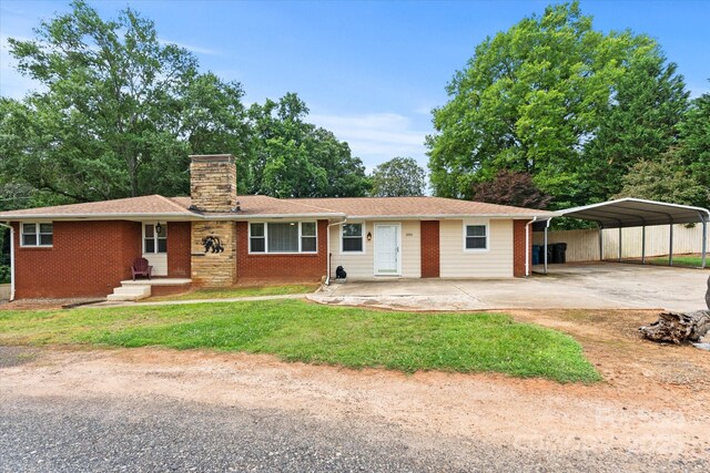 1810 13th Ave NE, Hickory, NC 28601 - single story home with concrete driveway, a chimney, brick siding, and a detached carport