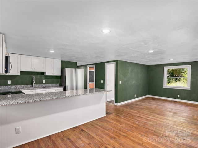 15 Burtiller Ln, Fletcher, NC 28732 - kitchen featuring appliances with stainless steel finishes, white cabinets, wood finished floors, a peninsula, and recessed lighting