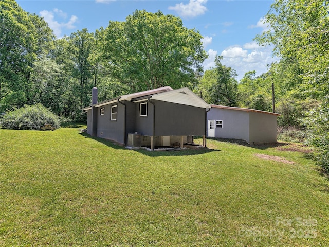 15 Burtiller Ln, Fletcher, NC 28732 - rear view of house featuring a lawn and central AC unit