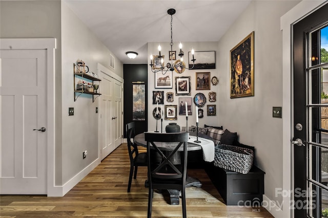 109 Druid Dr, Asheville, NC 28806 - dining space with a chandelier, wood finished floors, and baseboards