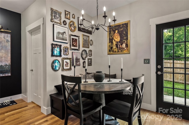 109 Druid Dr, Asheville, NC 28806 - dining room with light wood-type flooring, baseboards, and a chandelier