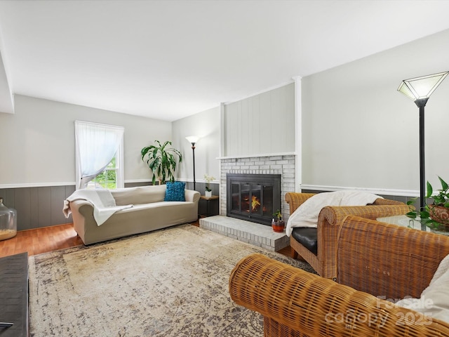 7317 Red Branch Ln, Charlotte, NC 28226 - living area with wood finished floors, a brick fireplace, and a wainscoted wall