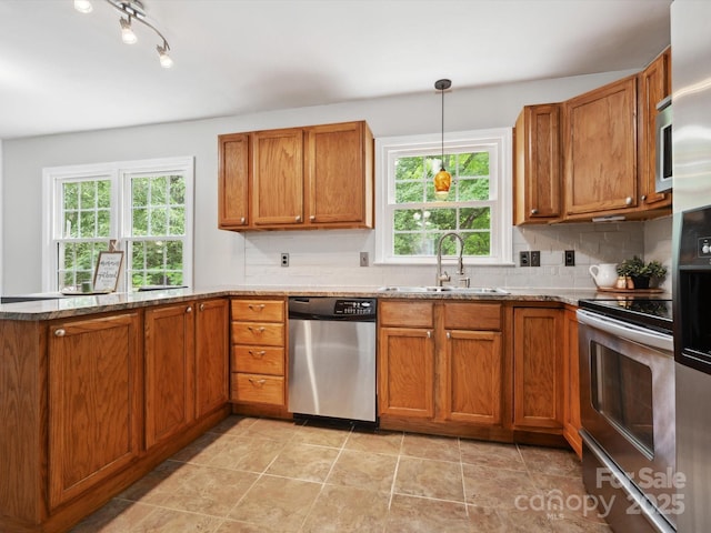 7317 Red Branch Ln, Charlotte, NC 28226 - kitchen with stainless steel appliances, a sink, and brown cabinets