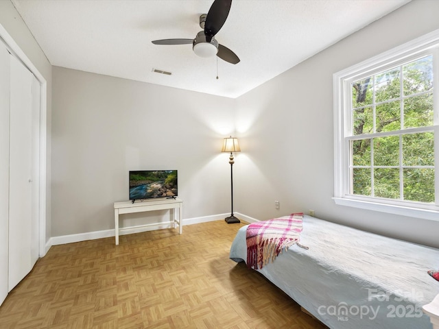 7317 Red Branch Ln, Charlotte, NC 28226 - bedroom with multiple windows, a closet, ceiling fan, and baseboards