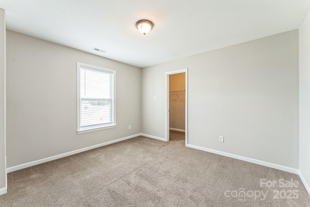 673 Shellbark Dr, Concord, NC 28025 - unfurnished bedroom featuring carpet floors, baseboards, and a spacious closet