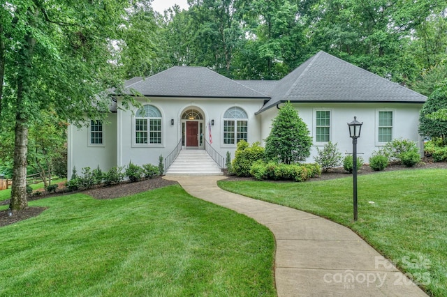 14831 Charterhouse Ln, Huntersville, NC 28078 - view of front of house with roof with shingles, stucco siding, and a front yard